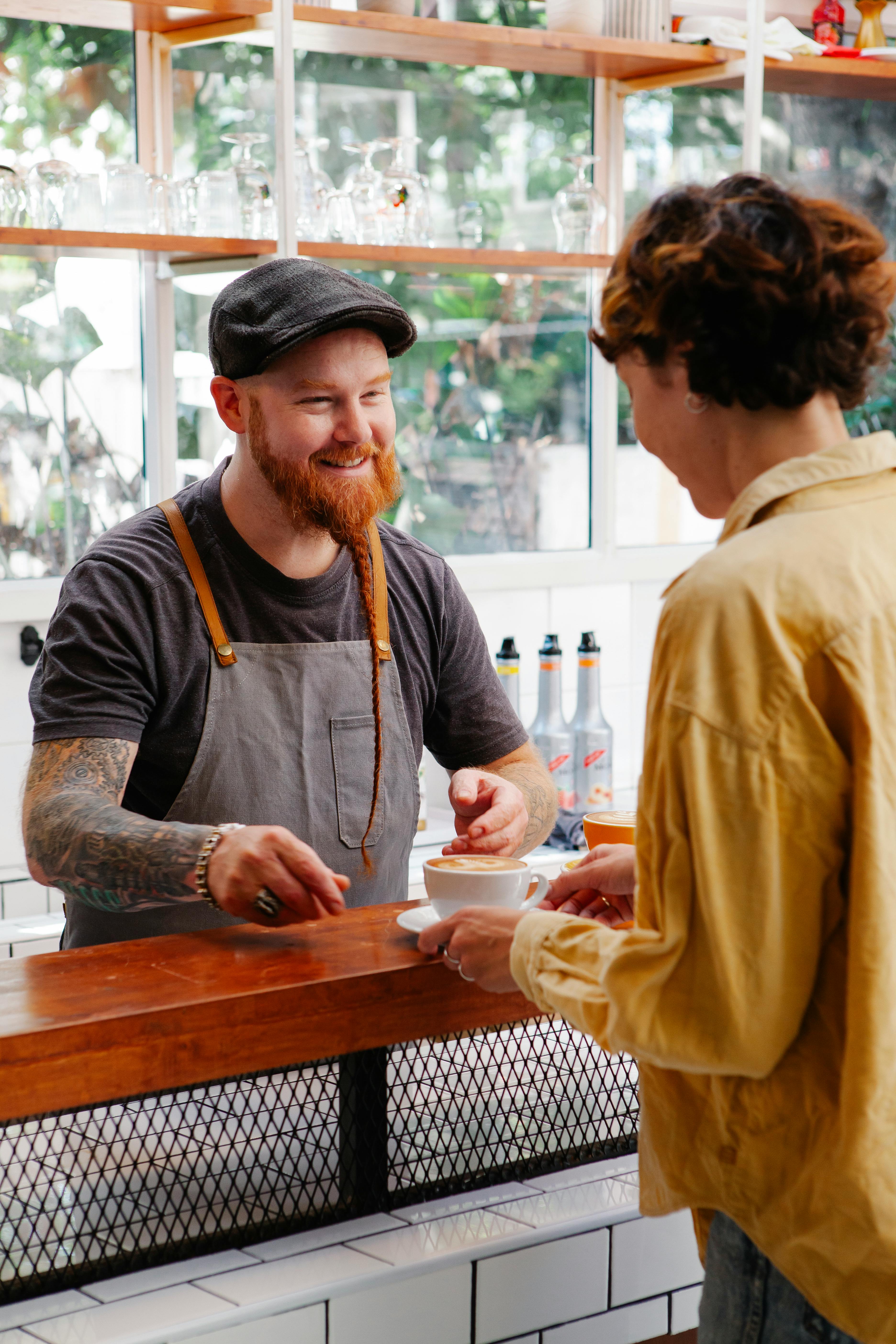 Barista serving coffee at Brew and Co